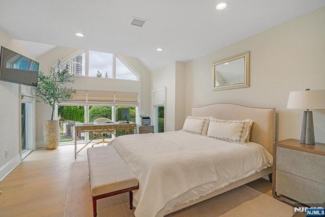 a bed room with a bed and a chair