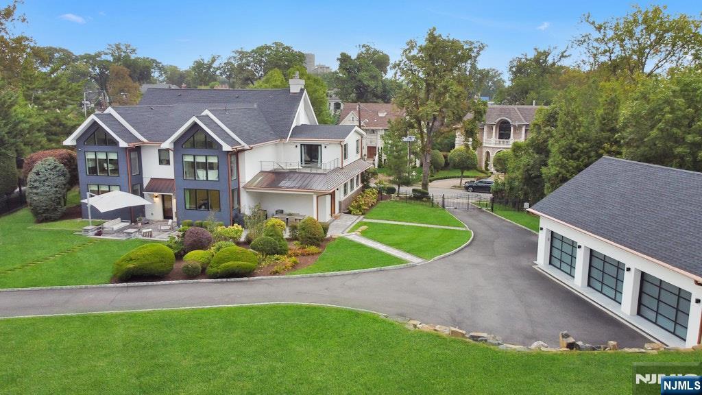 96 Bluff Road Fort Lee, NJ 07024 - Photo 20 of 22 a view of a house with a big yard potted plants and large tree