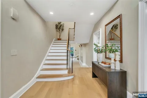 a view of entryway and hall with wooden floor