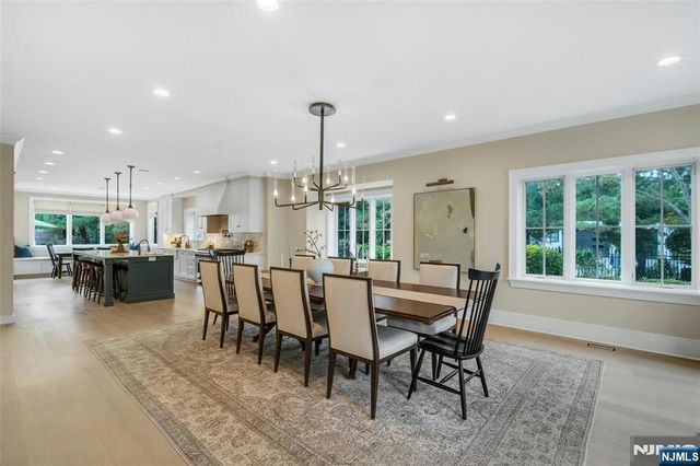 a dining room with furniture and a large window