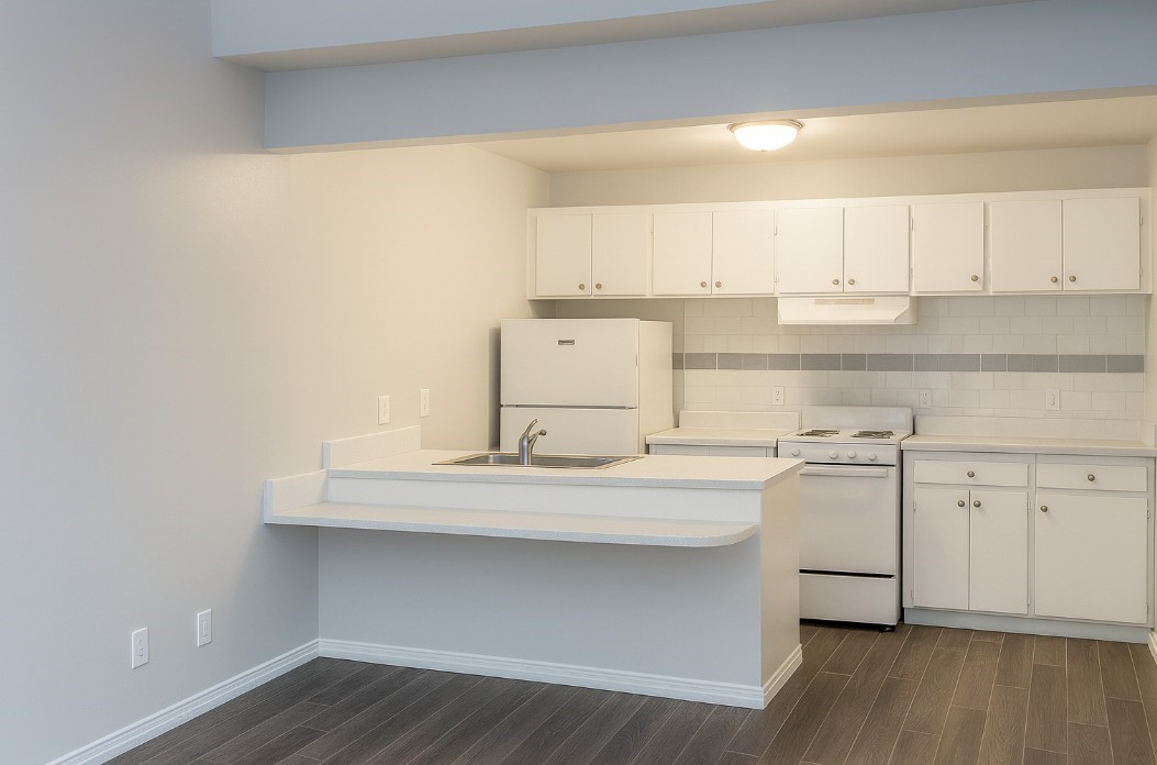 a kitchen with stainless steel appliances a sink and cabinets