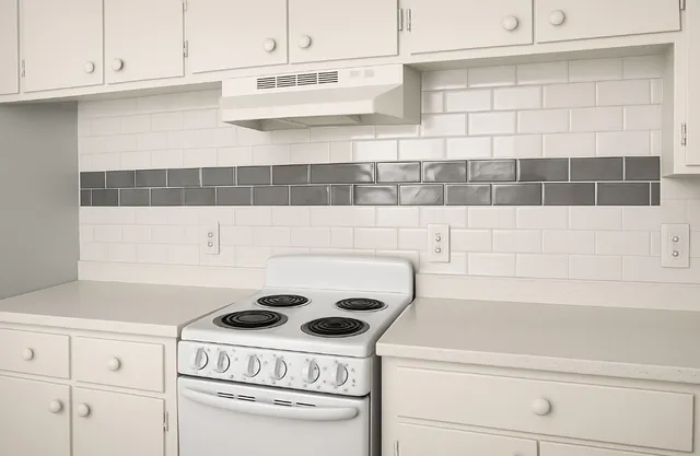 a close view of a utility room with dryer and cabinets