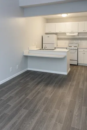 a view of a room with wooden floor