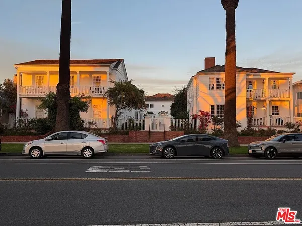 a view of cars parked on the side of a street