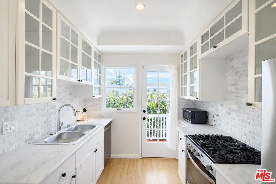 423 Ocean, Unit 2 Santa Monica, CA 90403 - Photo 12 of 18 a kitchen with a sink a stove and cabinets