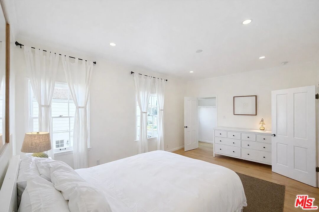 423 Ocean, Unit 2 Santa Monica, CA 90403 - Photo 17 of 18 a bedroom with a bed and a cabinets