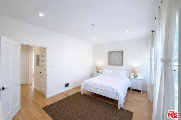 a bedroom with a bed and a night stand
