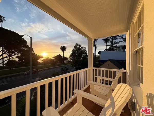 a view of a two chairs and table on the balcony