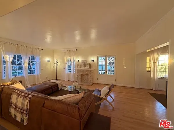 a living room with furniture a air conditioner vent and a window