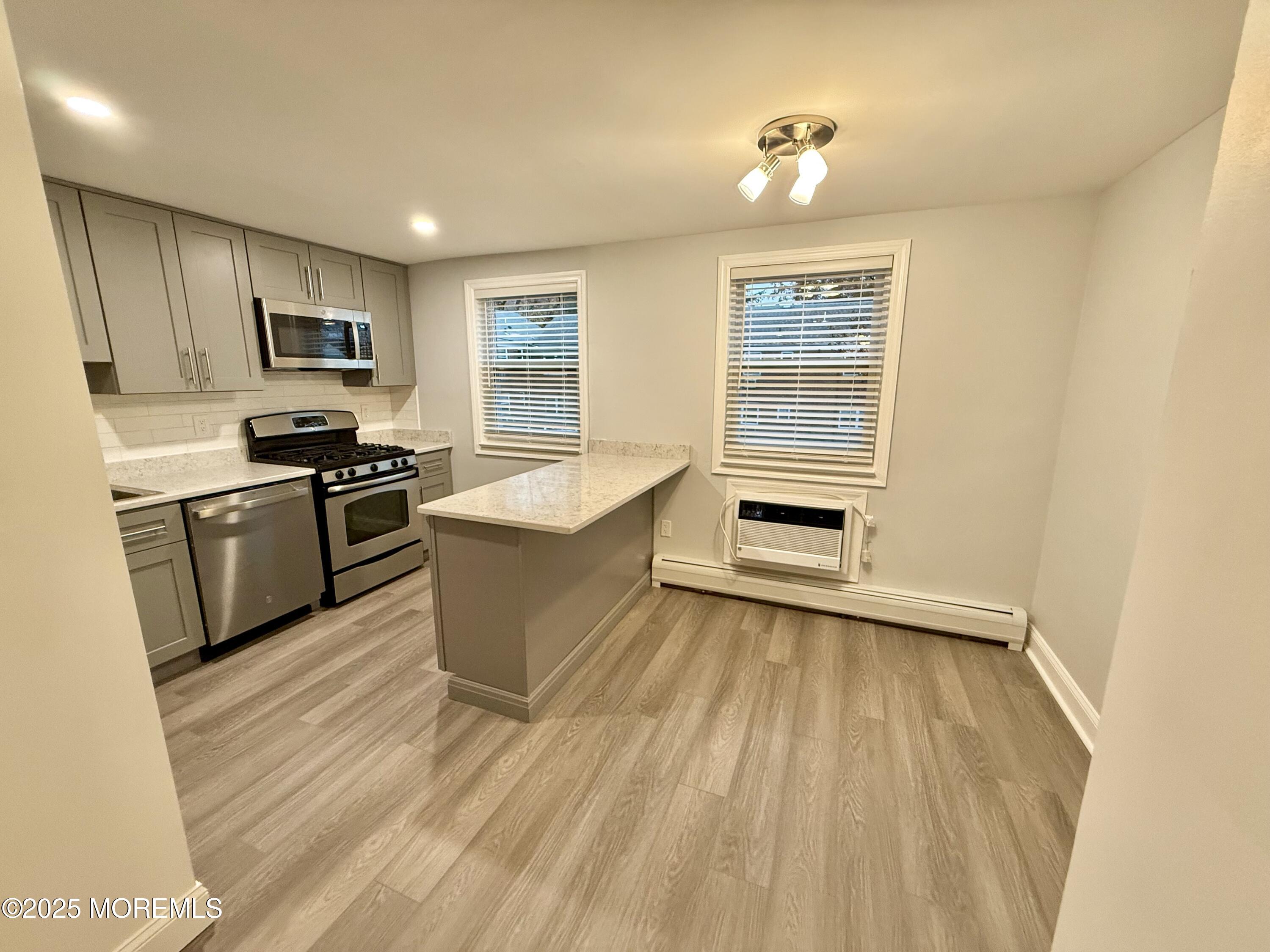 a kitchen with granite countertop a stove top oven and sink