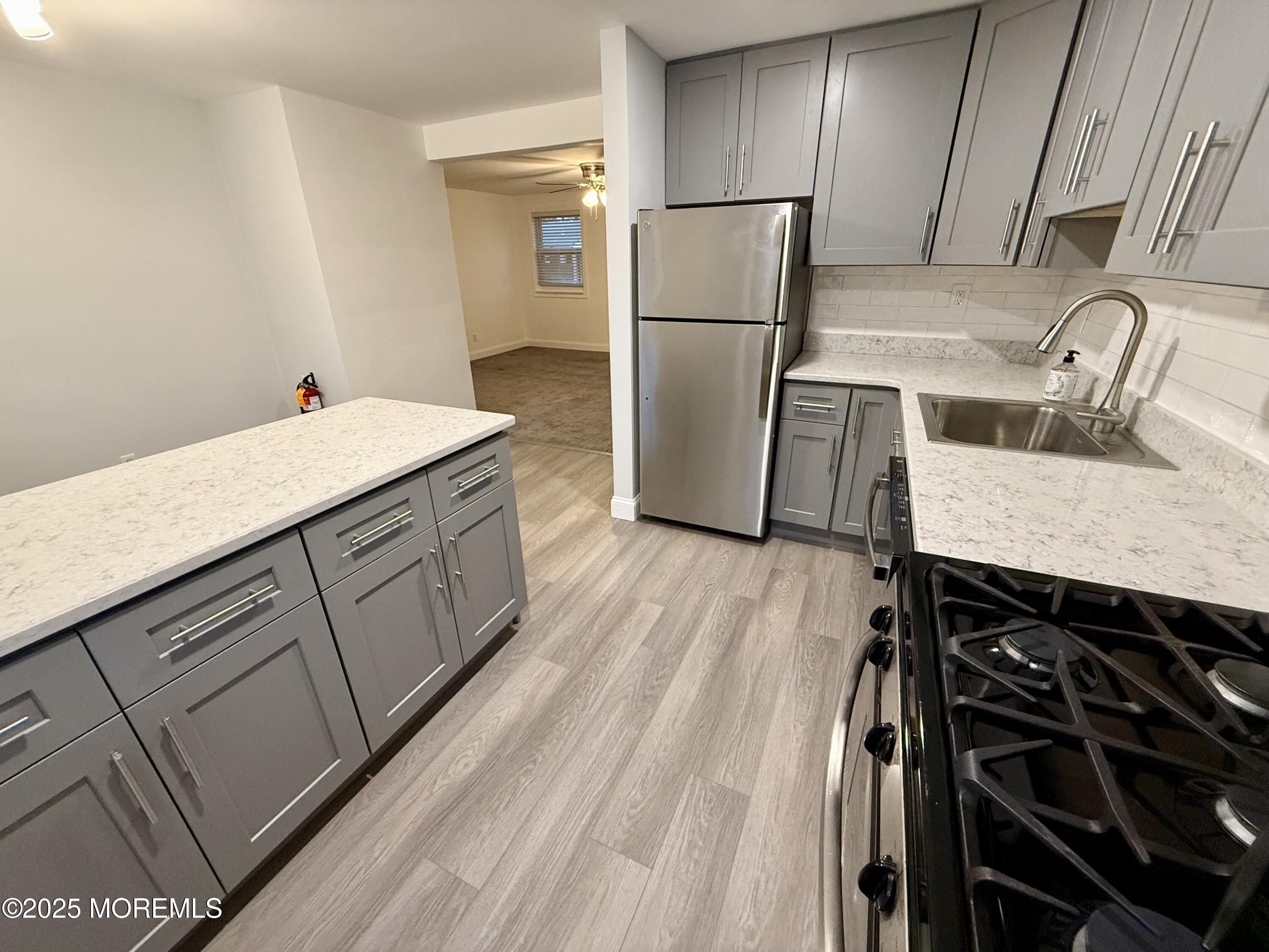 169 Manor Drive Red Bank, NJ 07701 - Photo 2 of 15 a kitchen with a sink appliances and cabinets