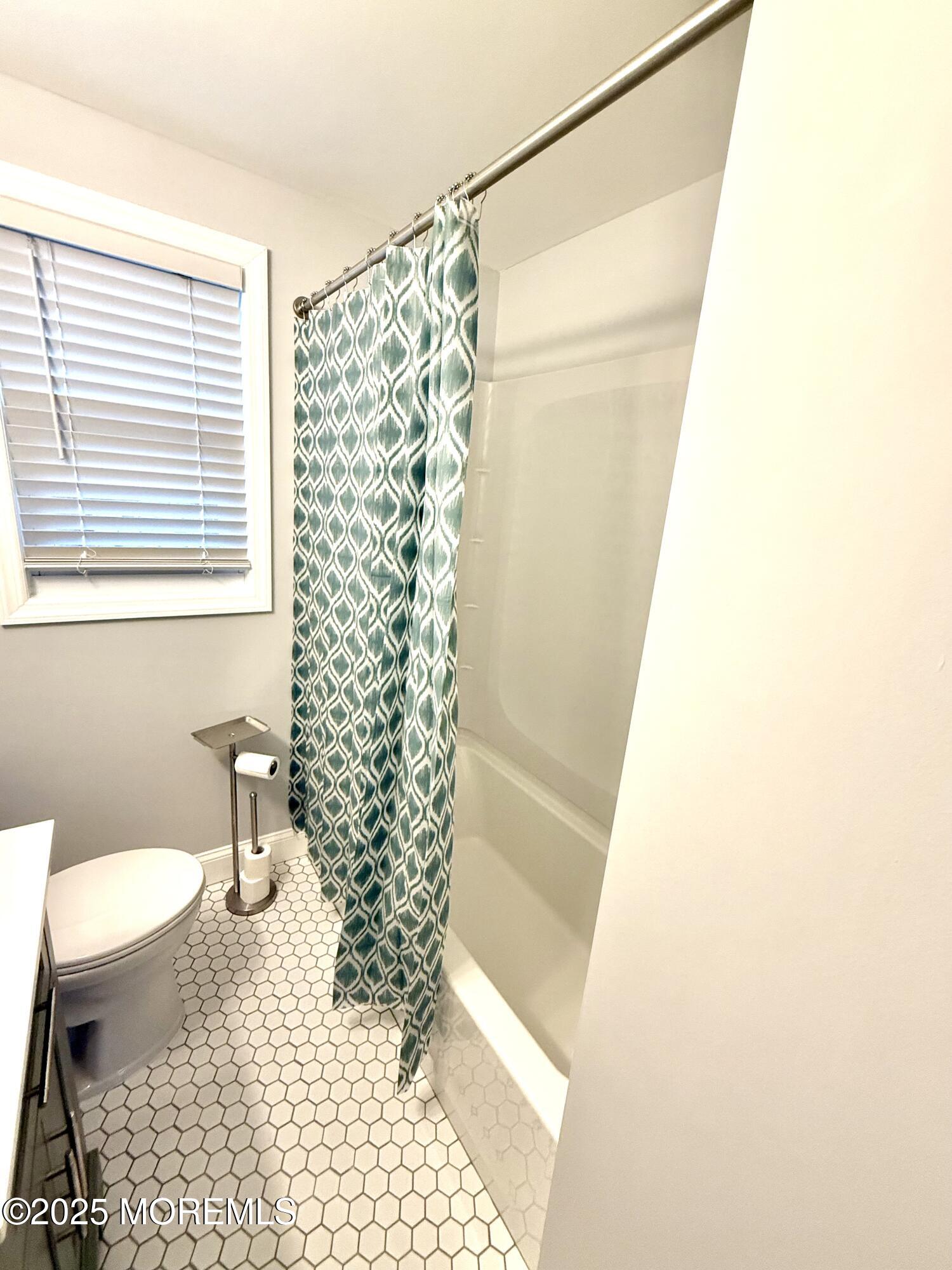 169 Manor Drive Red Bank, NJ 07701 - Photo 9 of 15 a bathroom with a shower curtain and a toilet