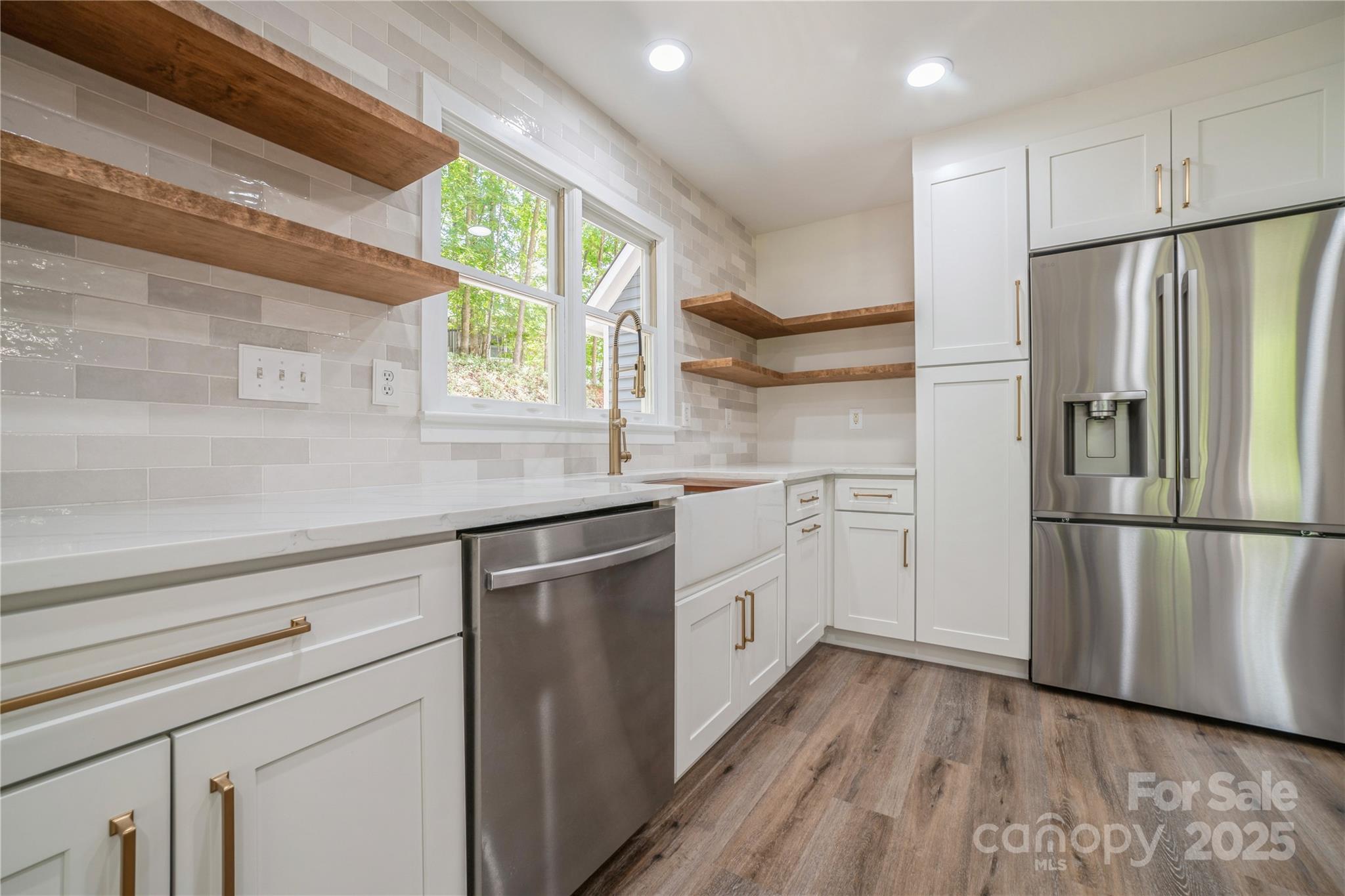 26056 Neptunes Landing Fort Mill, SC 29708 - Photo 13 of 47 a kitchen with white cabinets stainless steel appliances and window