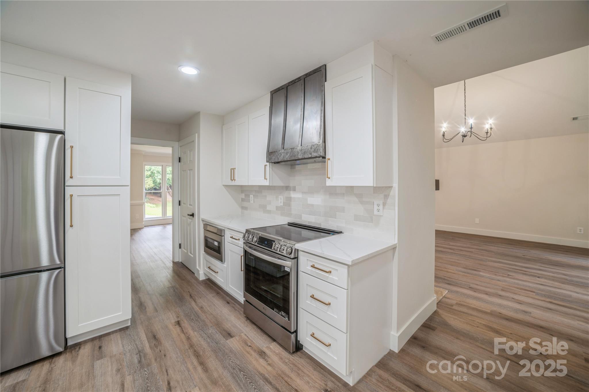 26056 Neptunes Landing Fort Mill, SC 29708 - Photo 15 of 47 a kitchen with stainless steel appliances a stove a refrigerator and a microwave