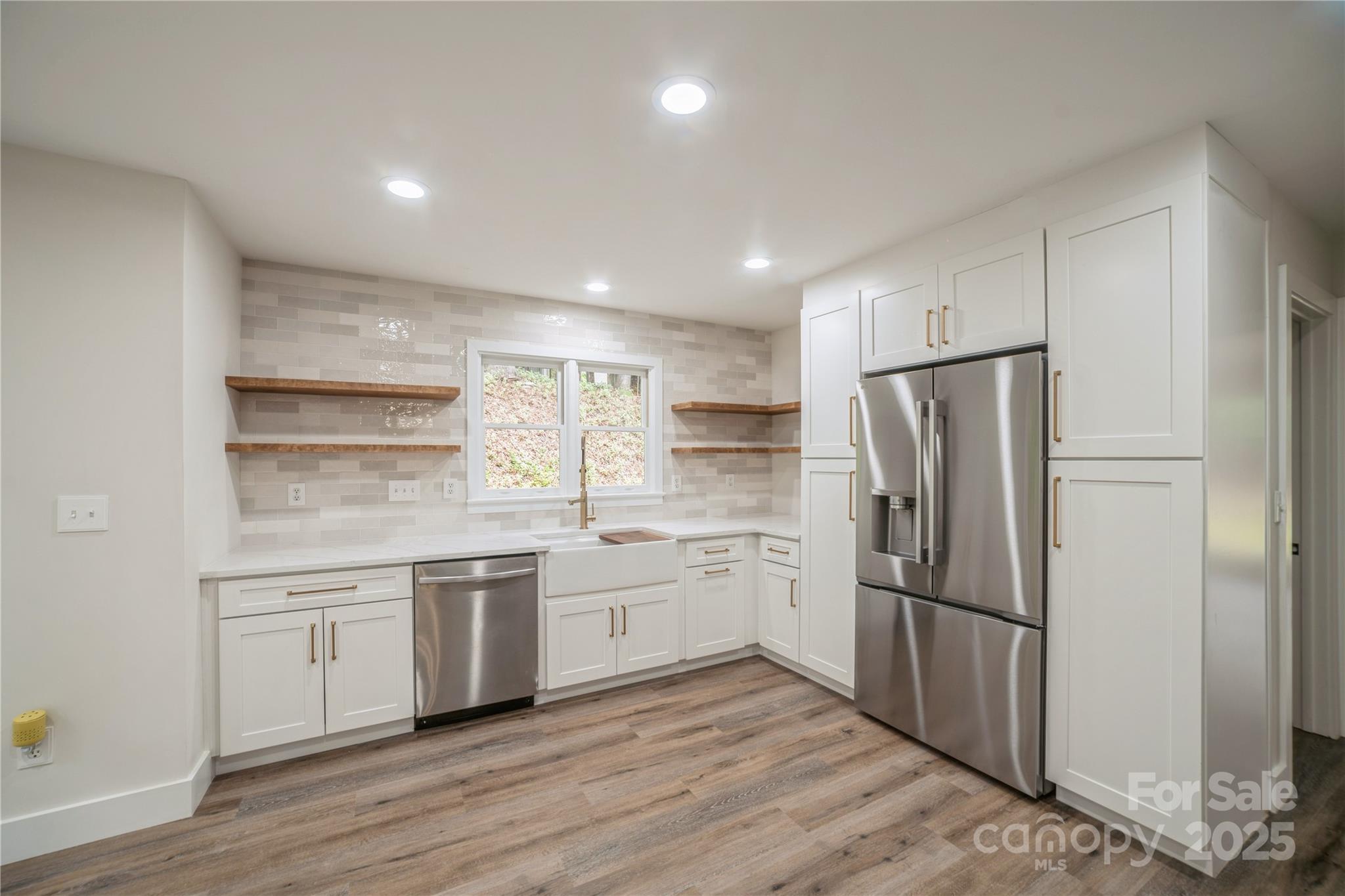 26056 Neptunes Landing Fort Mill, SC 29708 - Photo 16 of 47 a kitchen with a refrigerator and white cabinets