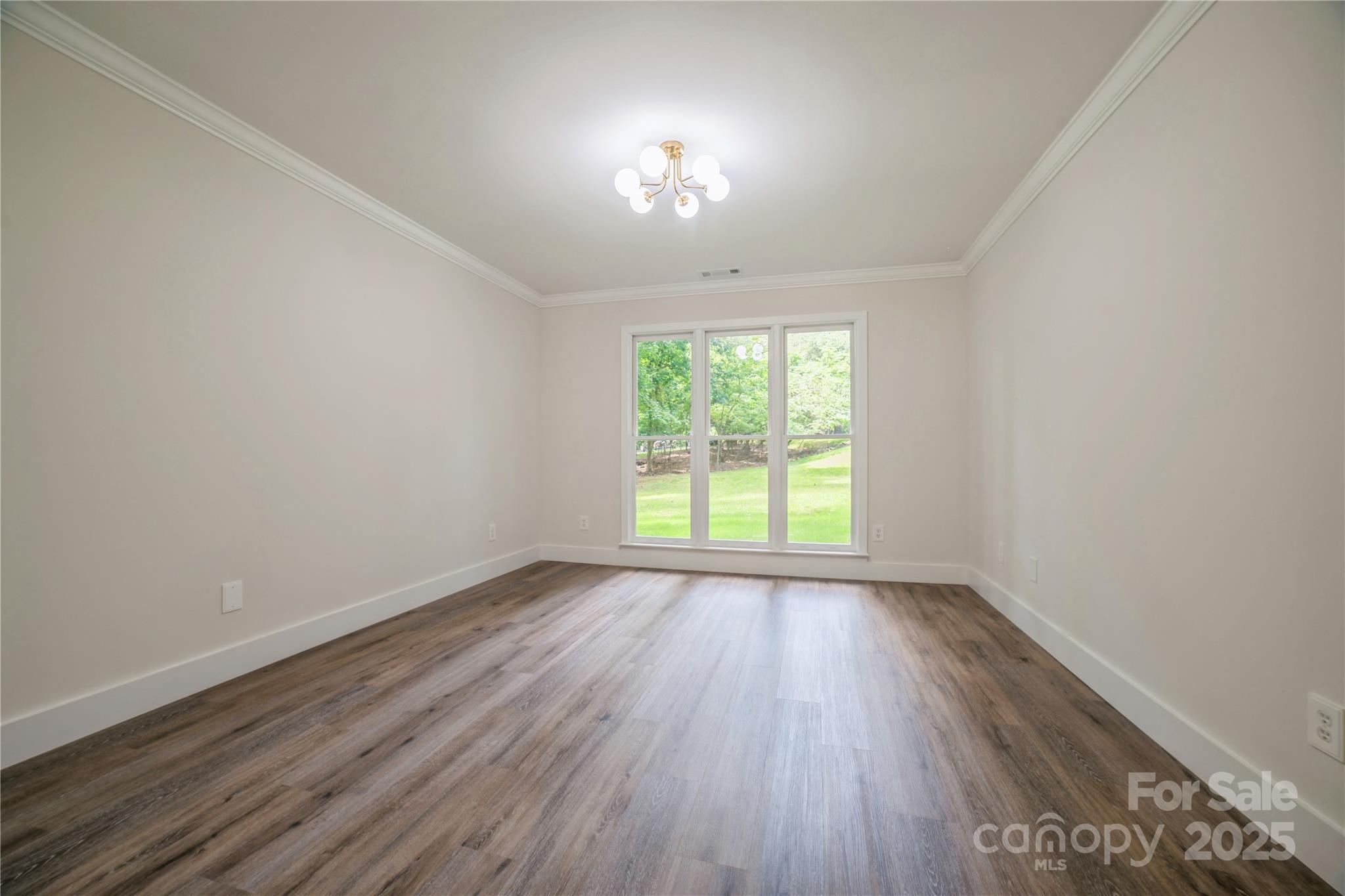 26056 Neptunes Landing Fort Mill, SC 29708 - Photo 17 of 47 an empty room with wooden floor and windows