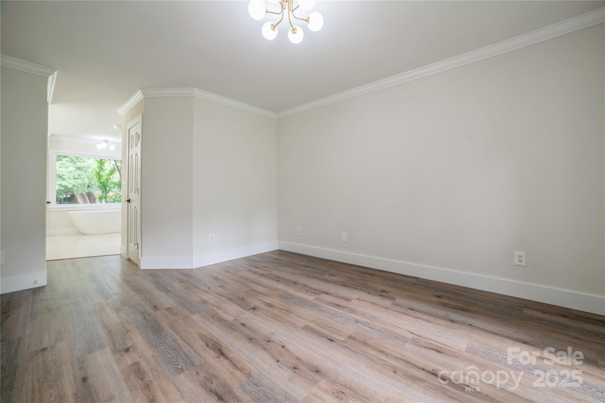 26056 Neptunes Landing Fort Mill, SC 29708 - Photo 18 of 47 a view of an empty room with wooden floor and a window