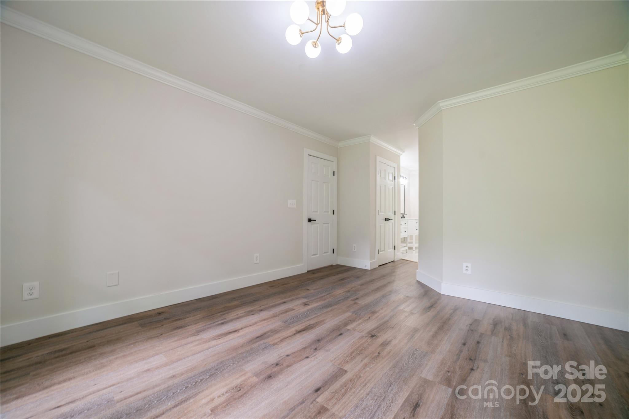 26056 Neptunes Landing Fort Mill, SC 29708 - Photo 19 of 47 a view of an empty room with wooden floor and a window
