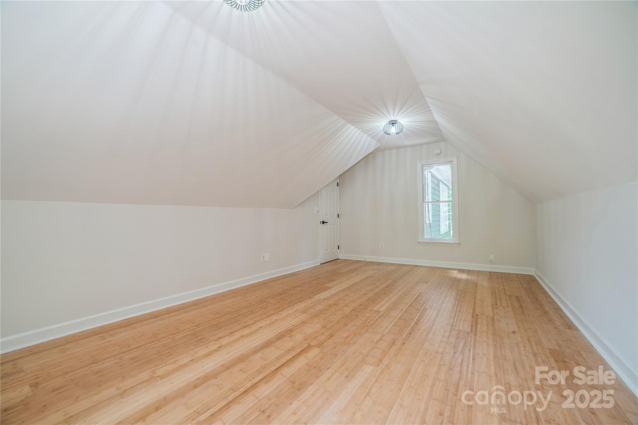 26056 Neptunes Landing Fort Mill, SC 29708 - Photo 32 of 47 an empty room with wooden floor and windows