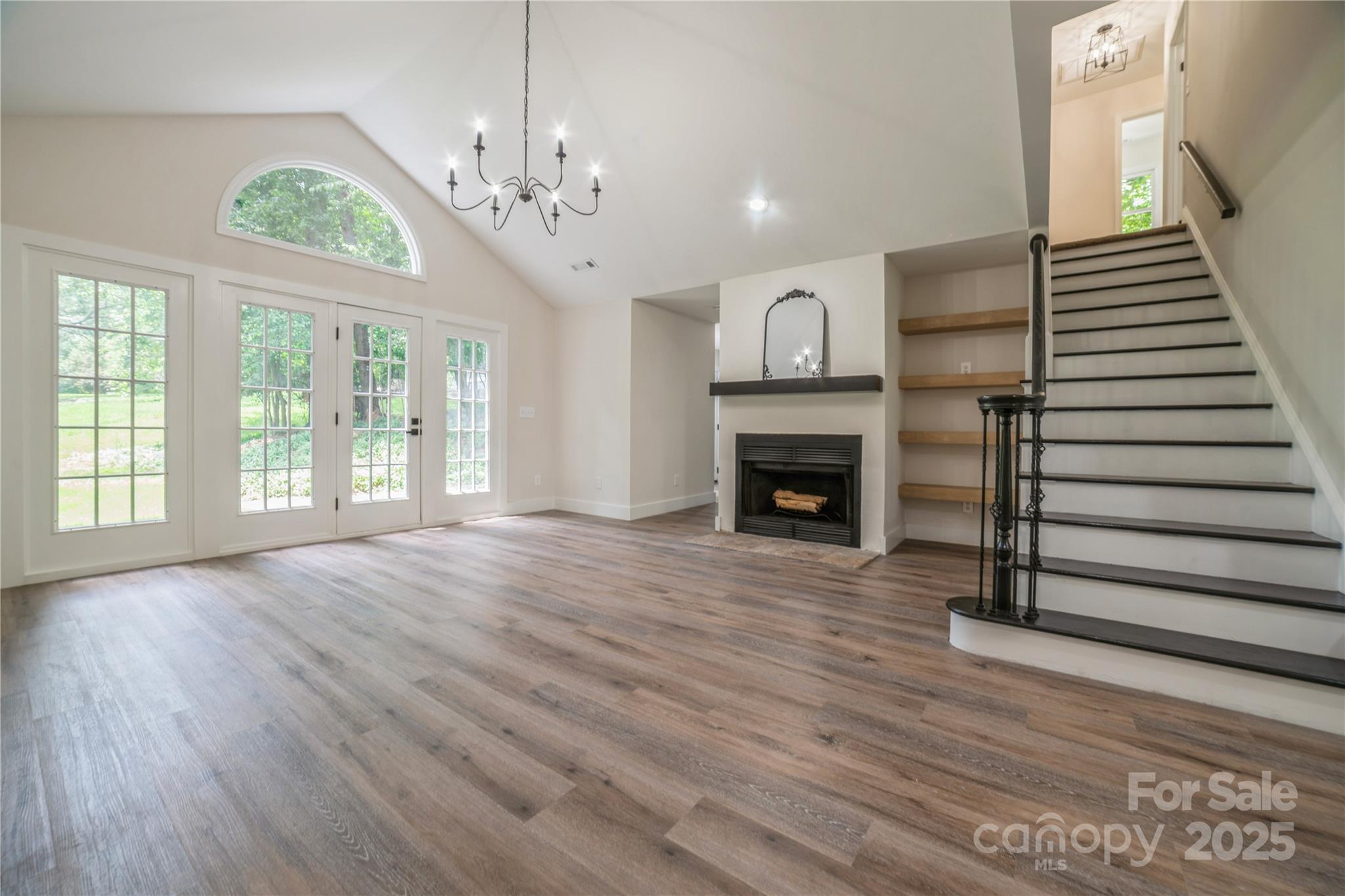 26056 Neptunes Landing Fort Mill, SC 29708 - Photo 4 of 47 a view of an empty room with wooden floor fireplace and a window