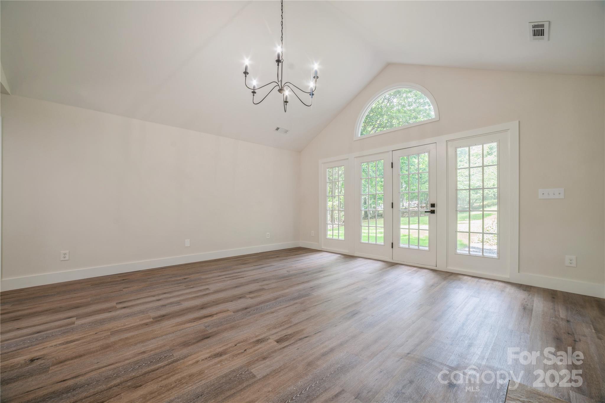 26056 Neptunes Landing Fort Mill, SC 29708 - Photo 5 of 47 a view of an empty room with wooden floor and a window
