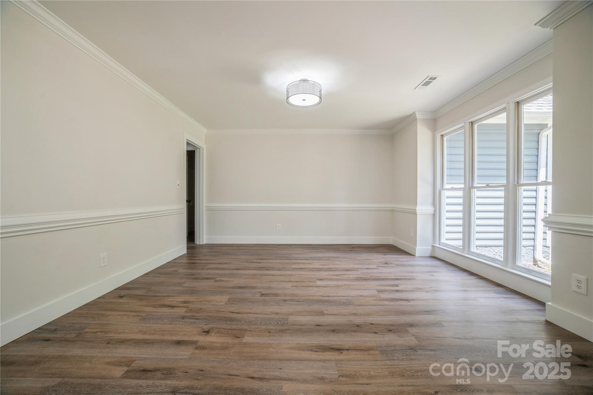 26056 Neptunes Landing Fort Mill, SC 29708 - Photo 9 of 47 a view of an empty room with wooden floor and a window