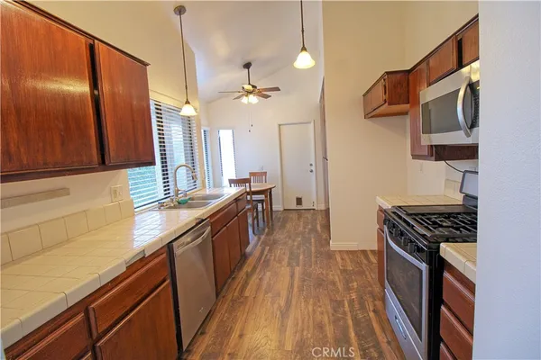a kitchen with stainless steel appliances a stove a sink and a refrigerator
