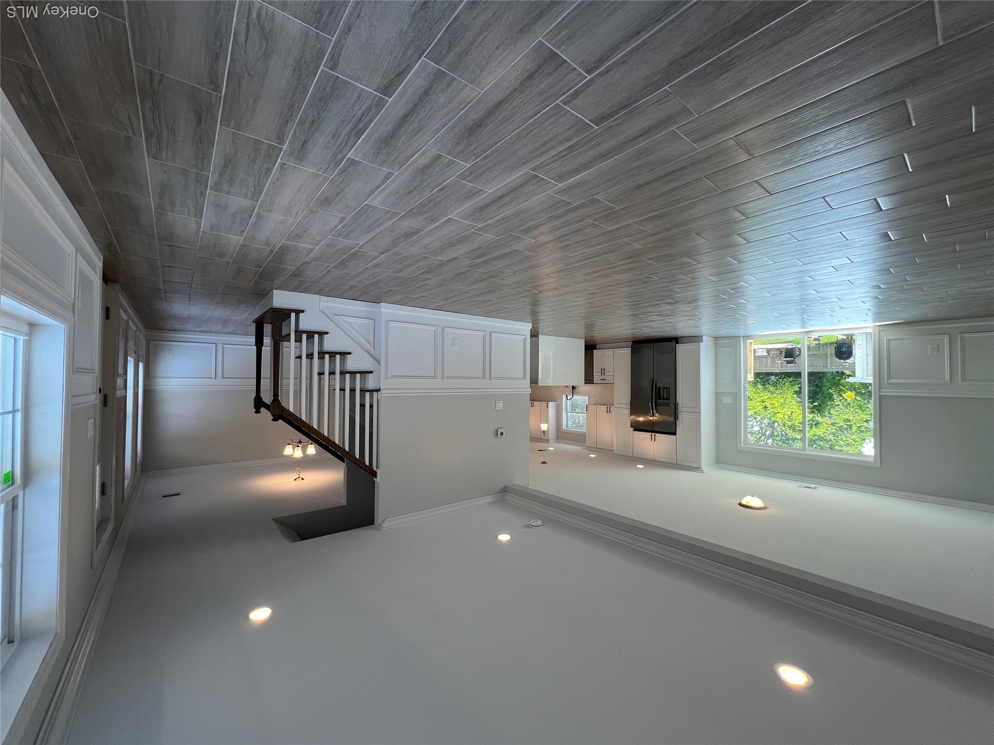 35 Babylon Road Mastic Beach, NY 11951 - Photo 3 of 19 a hallway and a kitchen with wooden floor