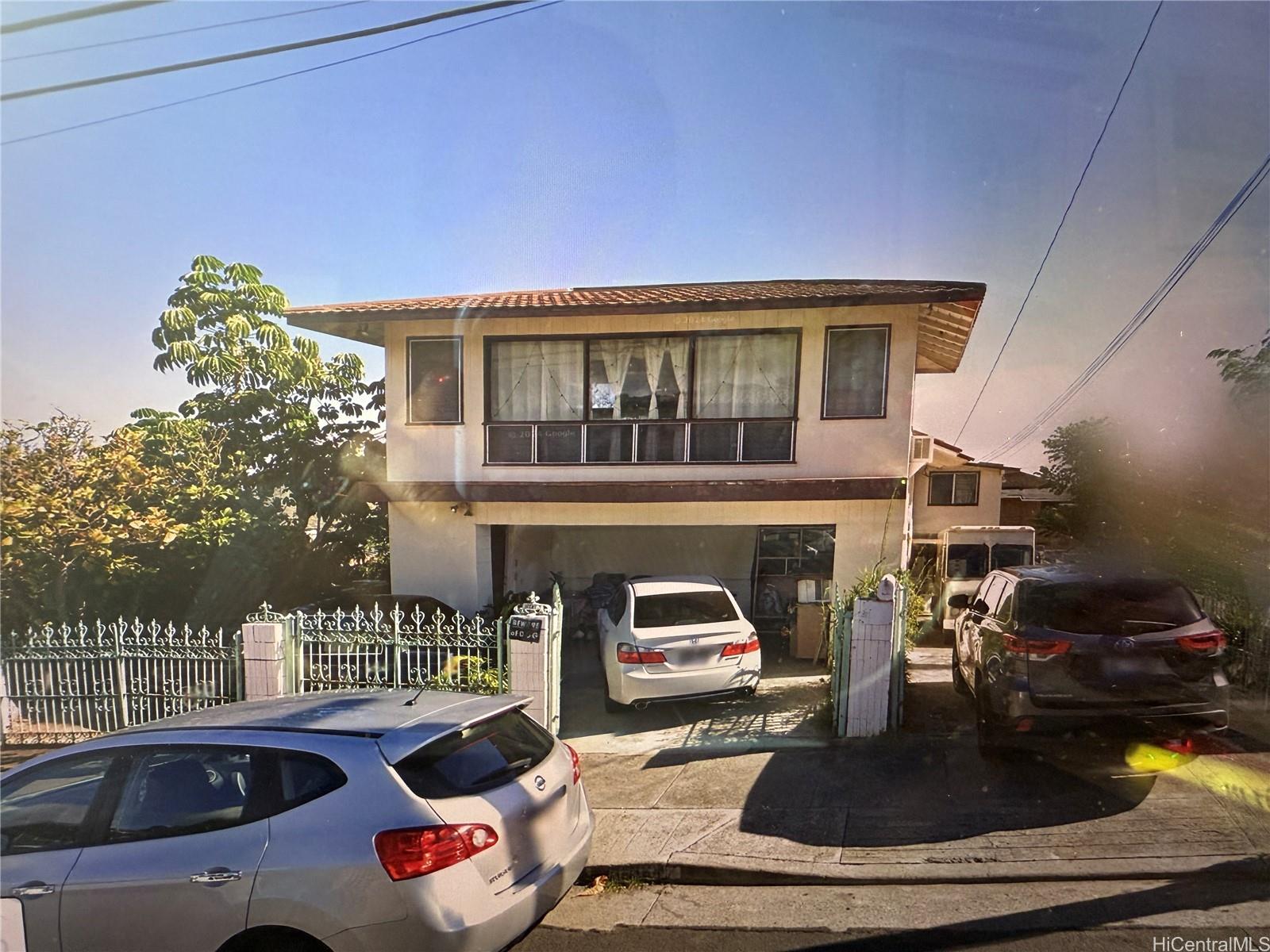3647 Likini Street Honolulu, HI 96818 - Photo 1 of 8 a front view of a house with outdoor seating