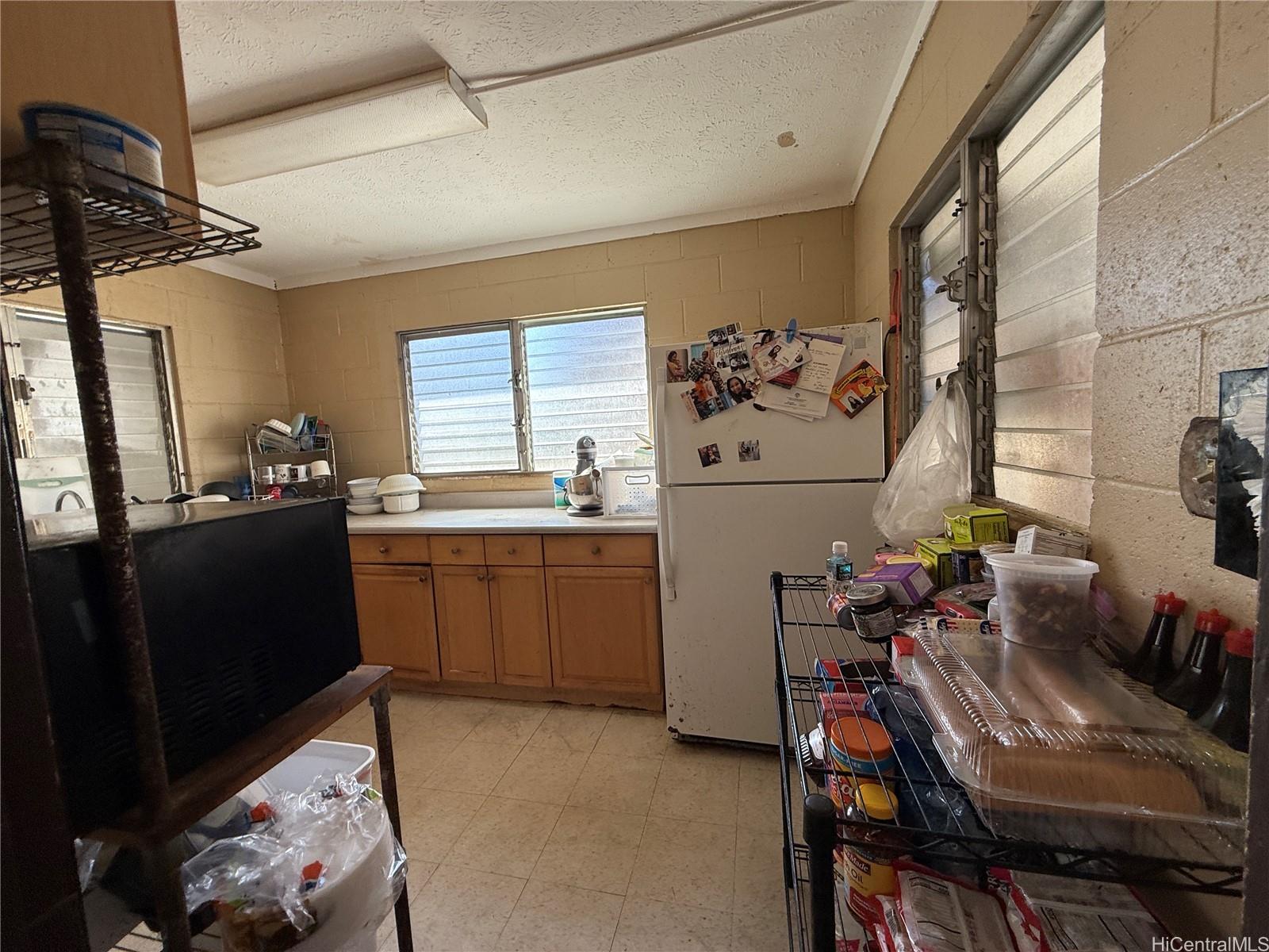 3647 Likini Street Honolulu, HI 96818 - Photo 6 of 8 a kitchen that has a sink and a stove in it