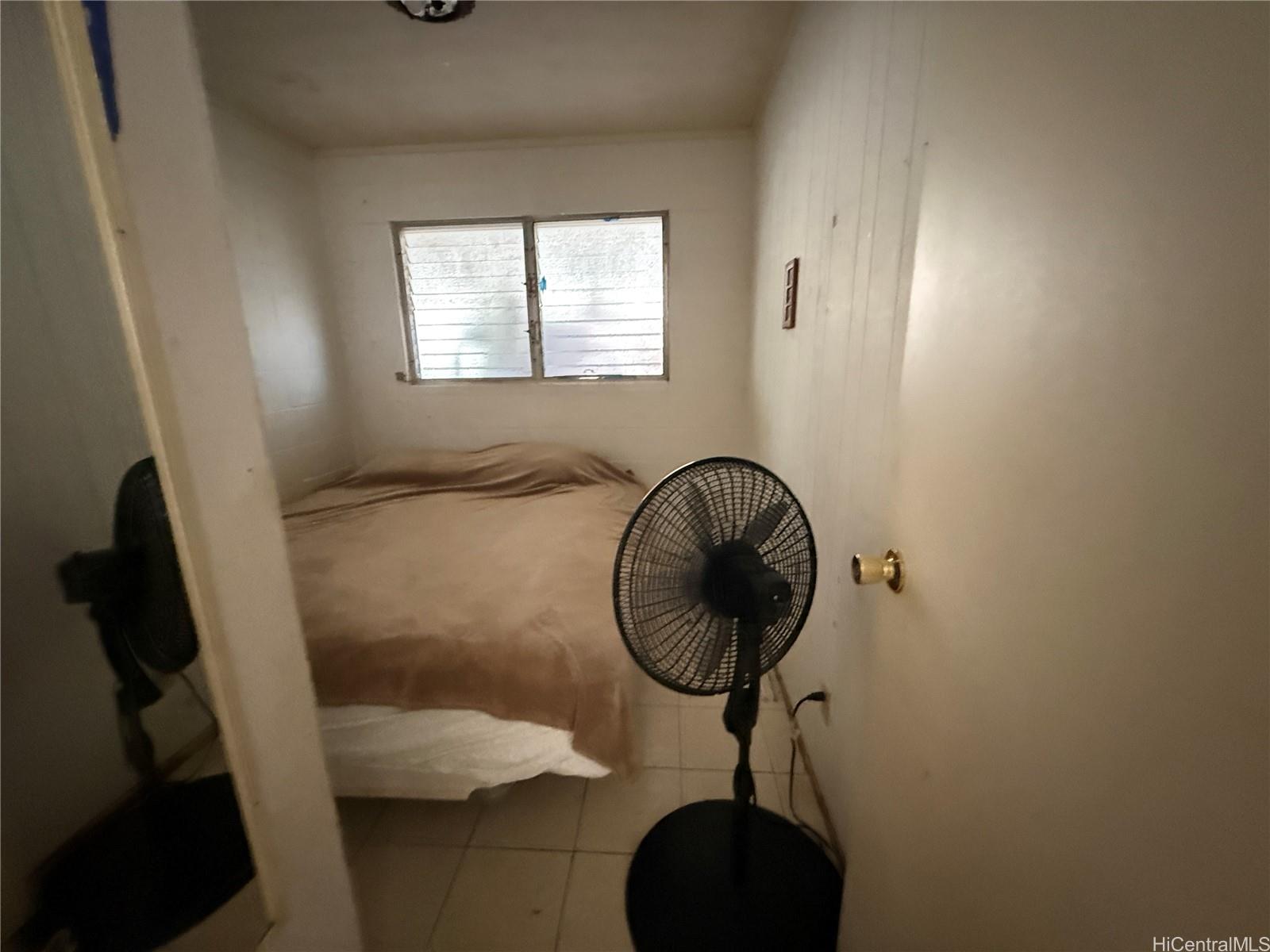 3647 Likini Street Honolulu, HI 96818 - Photo 8 of 8 a bathroom with a granite countertop sink a mirror and shower