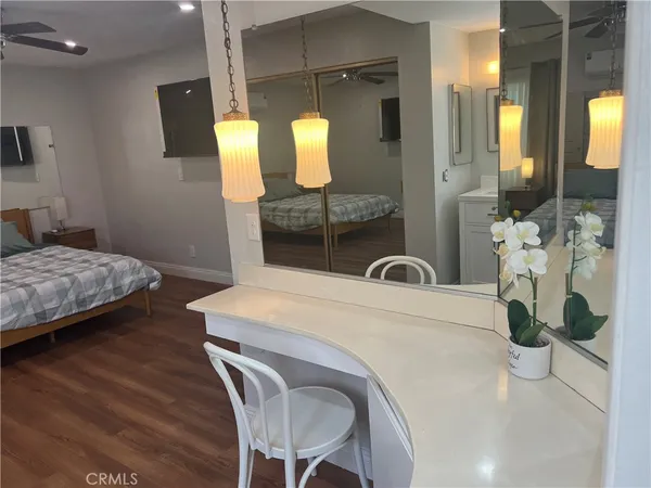 a en suite bathroom with a granite countertop sink and a mirror