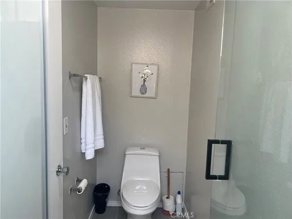 a white toilet sitting next to a bathroom sink