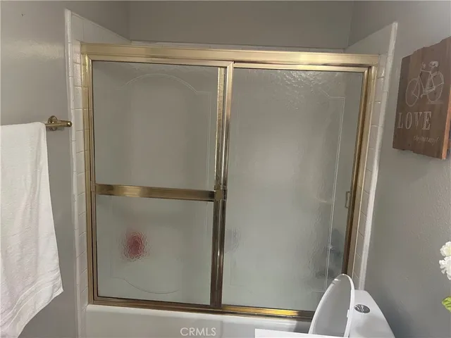 a bathroom with a glass shower door