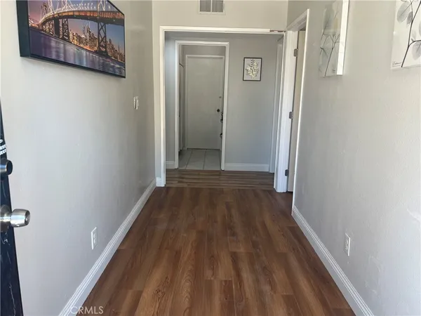 a view of a hallway with wooden floor