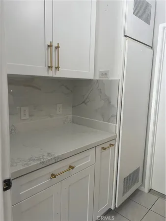 a view white cabinets and a refrigerator