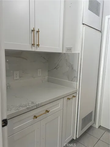 a view white cabinets and a refrigerator