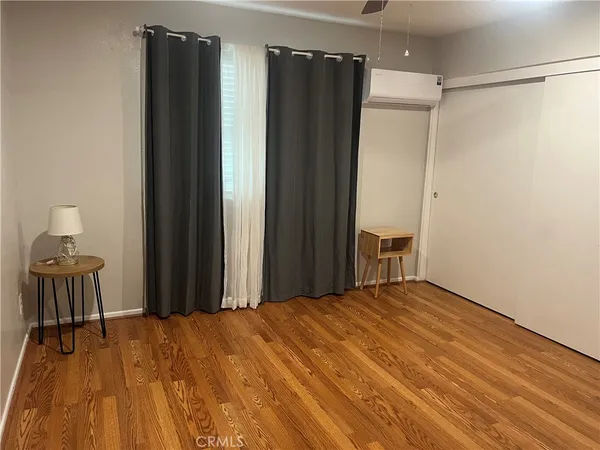 a bedroom with a bed and a refrigerator