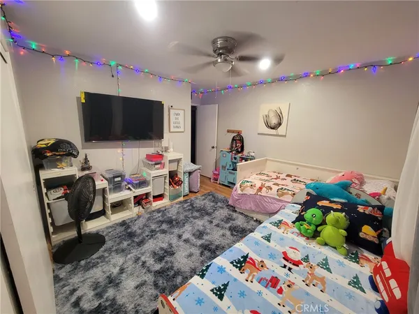 a bed room with a bed a flat screen tv and a couch