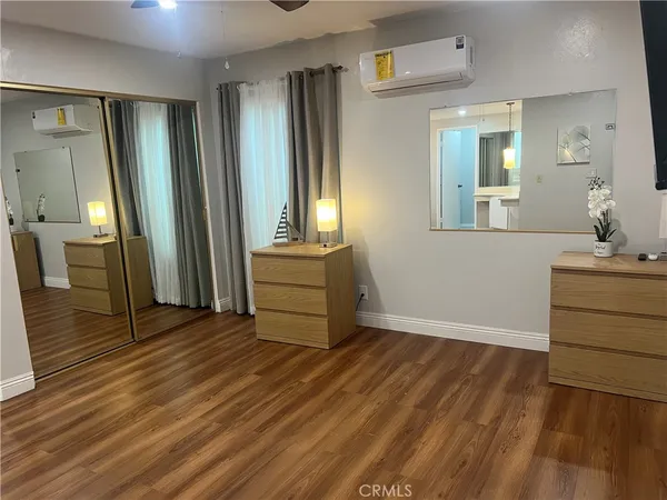 wooden floor in an empty room with a mirror