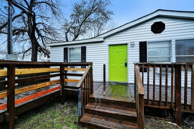 a backyard of a house with barbeque oven table and chairs