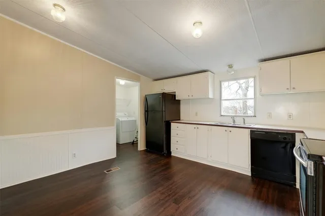 a kitchen with a refrigerator and window