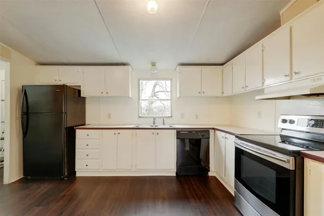 a kitchen with a sink stove and refrigerator