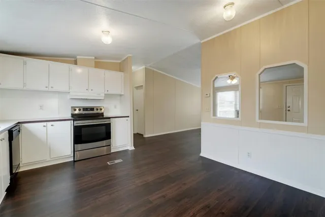 a kitchen with granite countertop white cabinets and white appliances