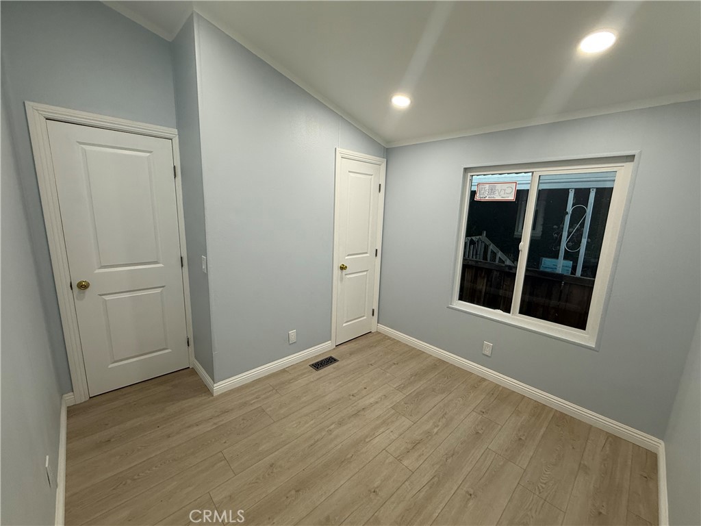 716 North Grand, Unit D3 Covina, CA 91724 - Photo 21 of 35 an empty room with wooden floor and windows