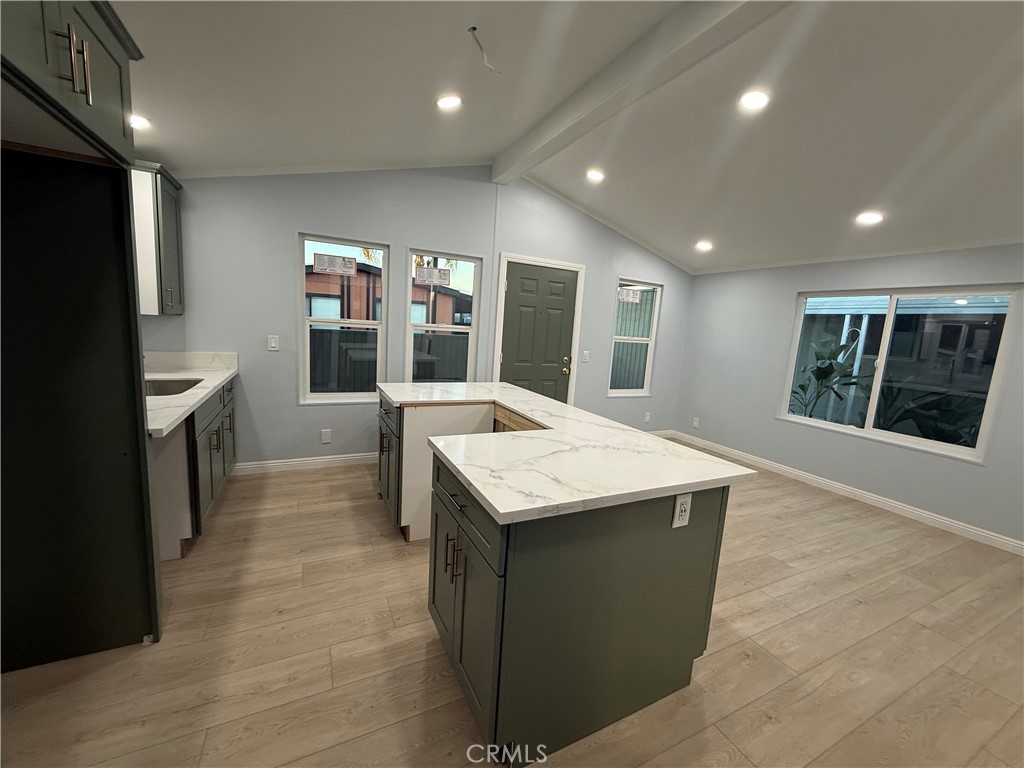 716 North Grand, Unit D3 Covina, CA 91724 - Photo 30 of 35 a kitchen with a stove and a kitchen island