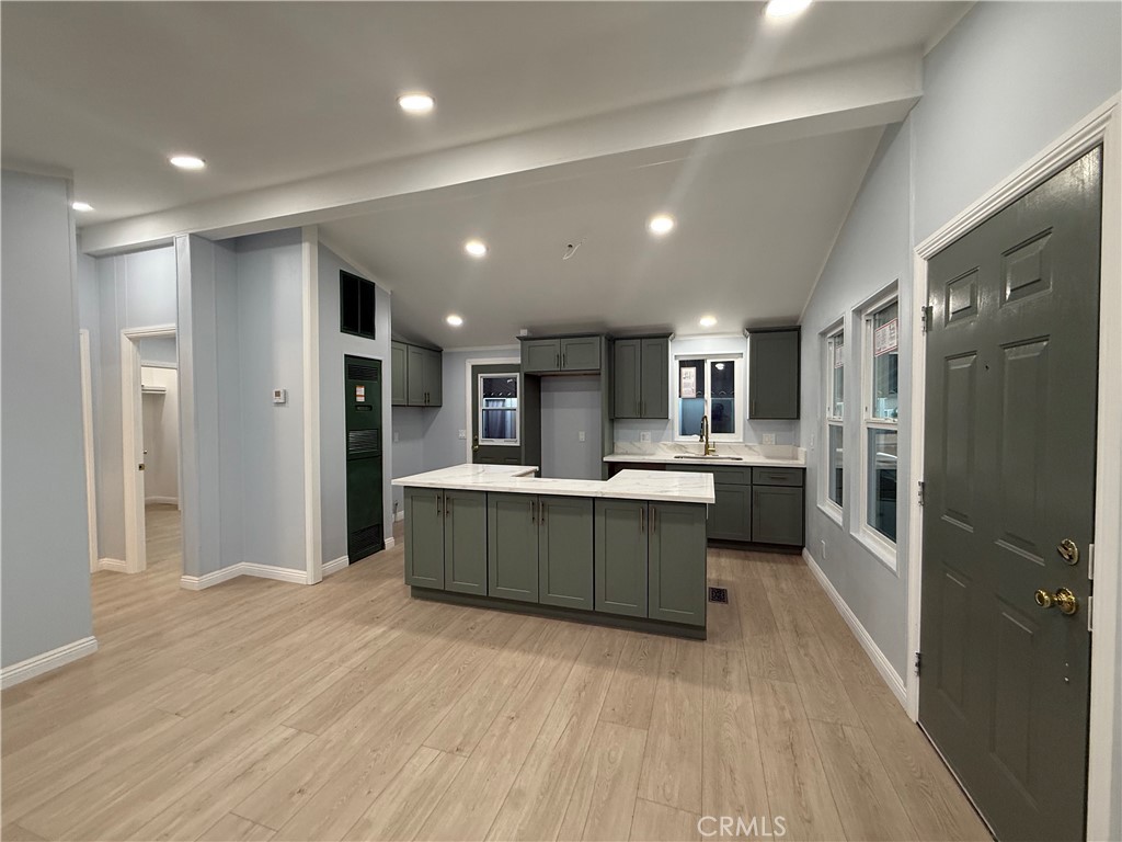 716 North Grand, Unit D3 Covina, CA 91724 - Photo 31 of 35 a kitchen with stainless steel appliances kitchen island granite countertop a refrigerator and a sink