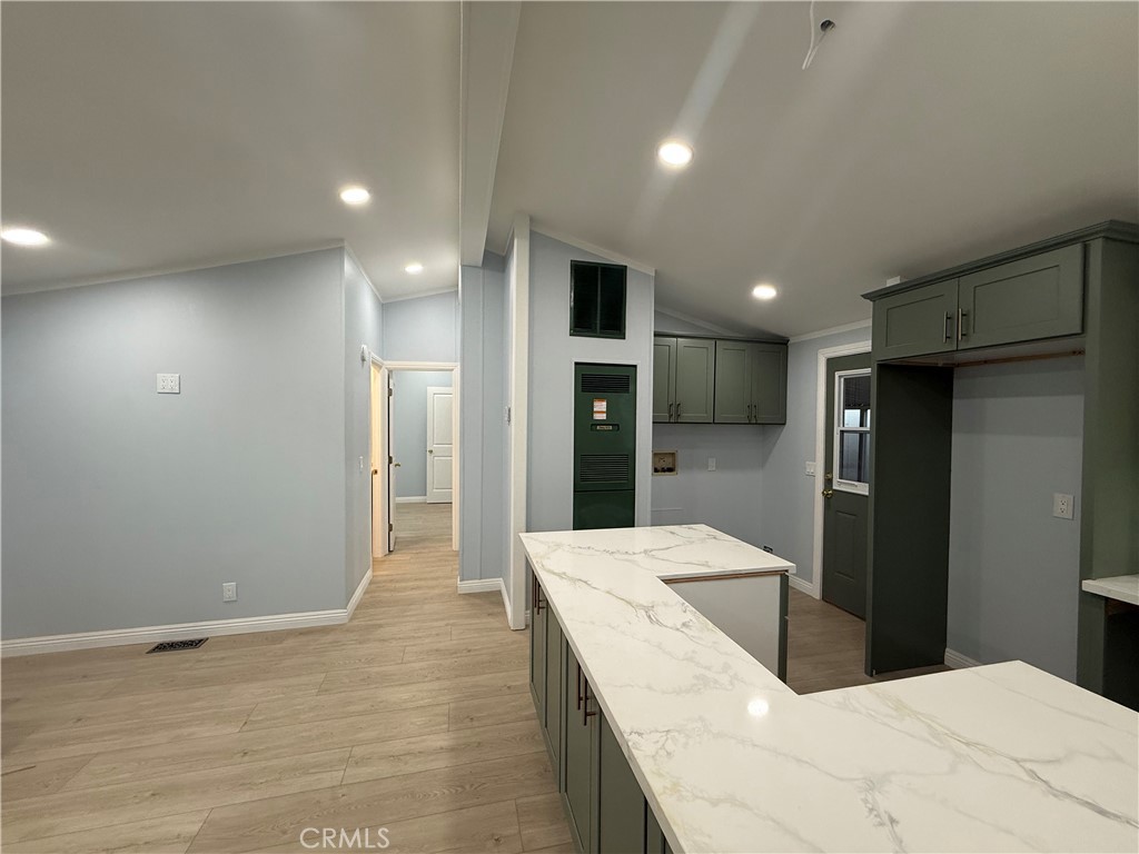 716 North Grand, Unit D3 Covina, CA 91724 - Photo 32 of 35 a large white kitchen with a refrigerator and a sink