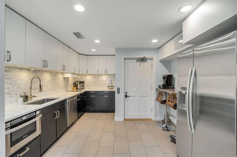 1678 Nottingham Way Northeast Atlanta, GA 30309 - Photo 37 of 57 a kitchen with a sink a refrigerator and cabinets