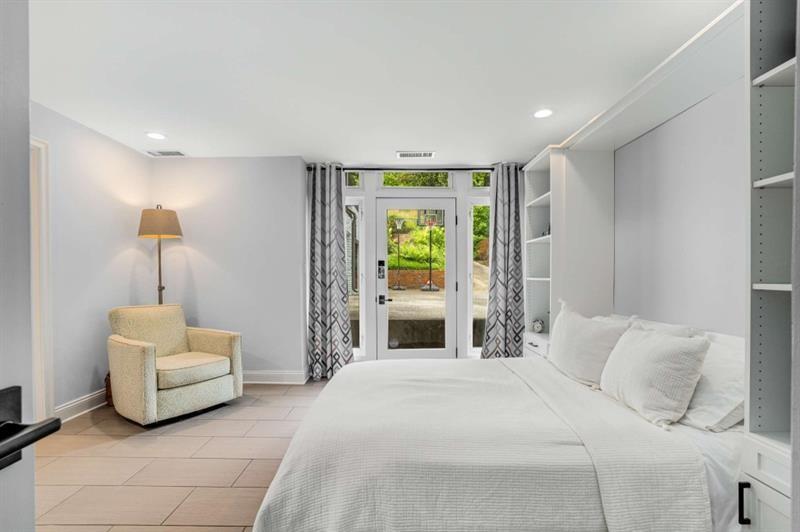 1678 Nottingham Way Northeast Atlanta, GA 30309 - Photo 38 of 57 a bedroom with a bed and a couch